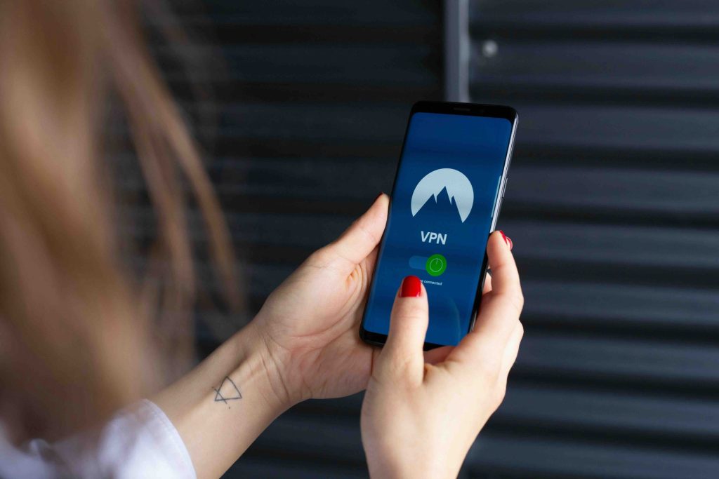 Woman holding a phone looking at a VPN app